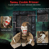 Hanging animated zombie prisoner decoration with glowing red eyes and detailed hands, perfect for Halloween scares.