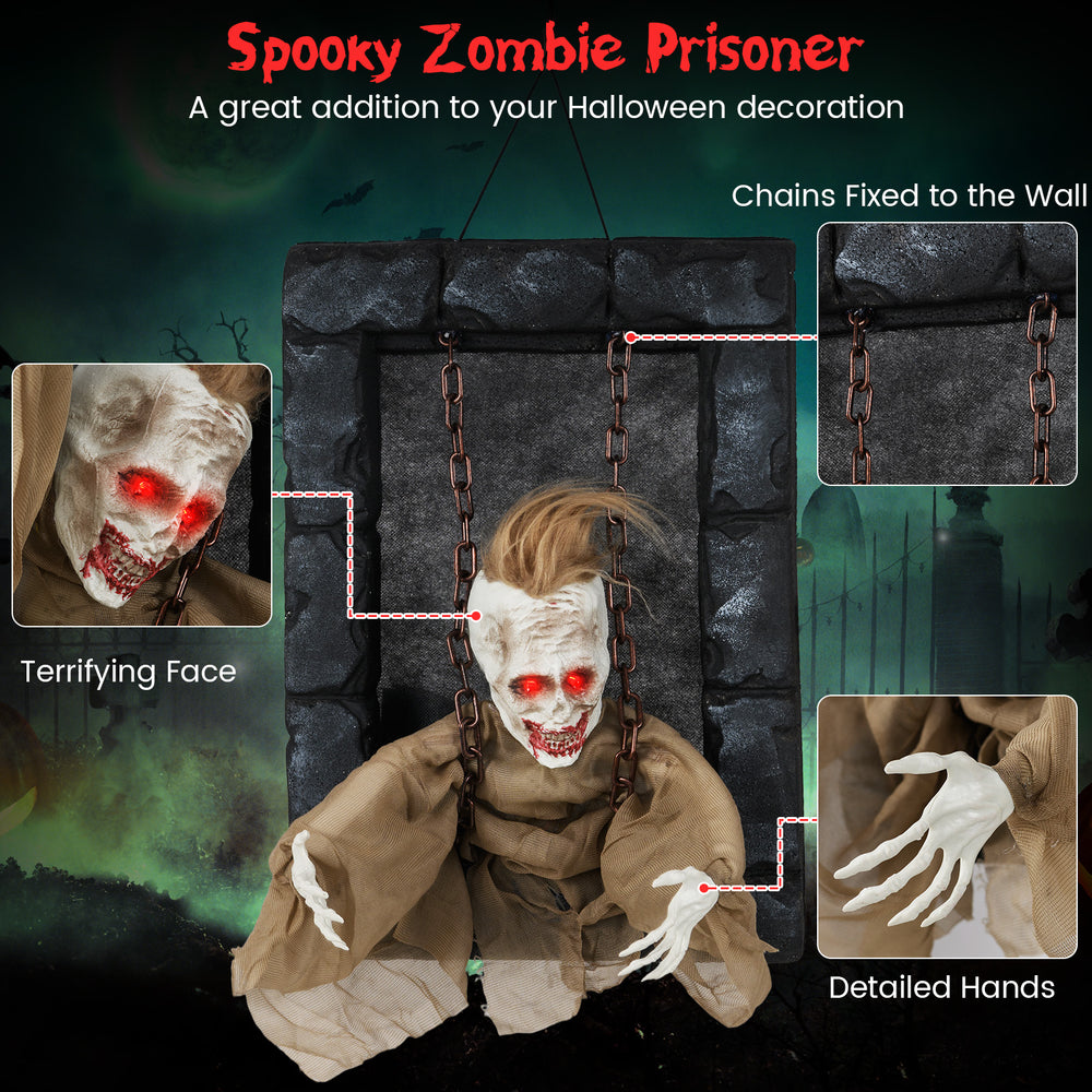 Hanging animated zombie prisoner decoration with glowing red eyes and detailed hands, perfect for Halloween scares.