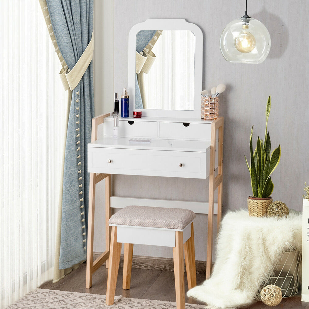 Vanity table set with cushioned stool and large mirror, featuring three drawers and a stylish white finish for elegant.