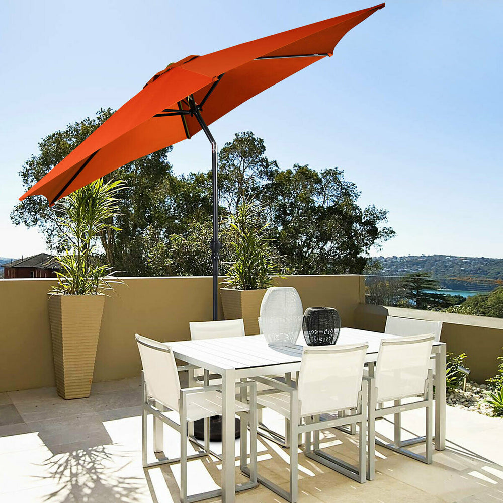 9 ft orange patio umbrella with crank, featuring a sturdy steel pole, providing shade for outdoor dining areas.