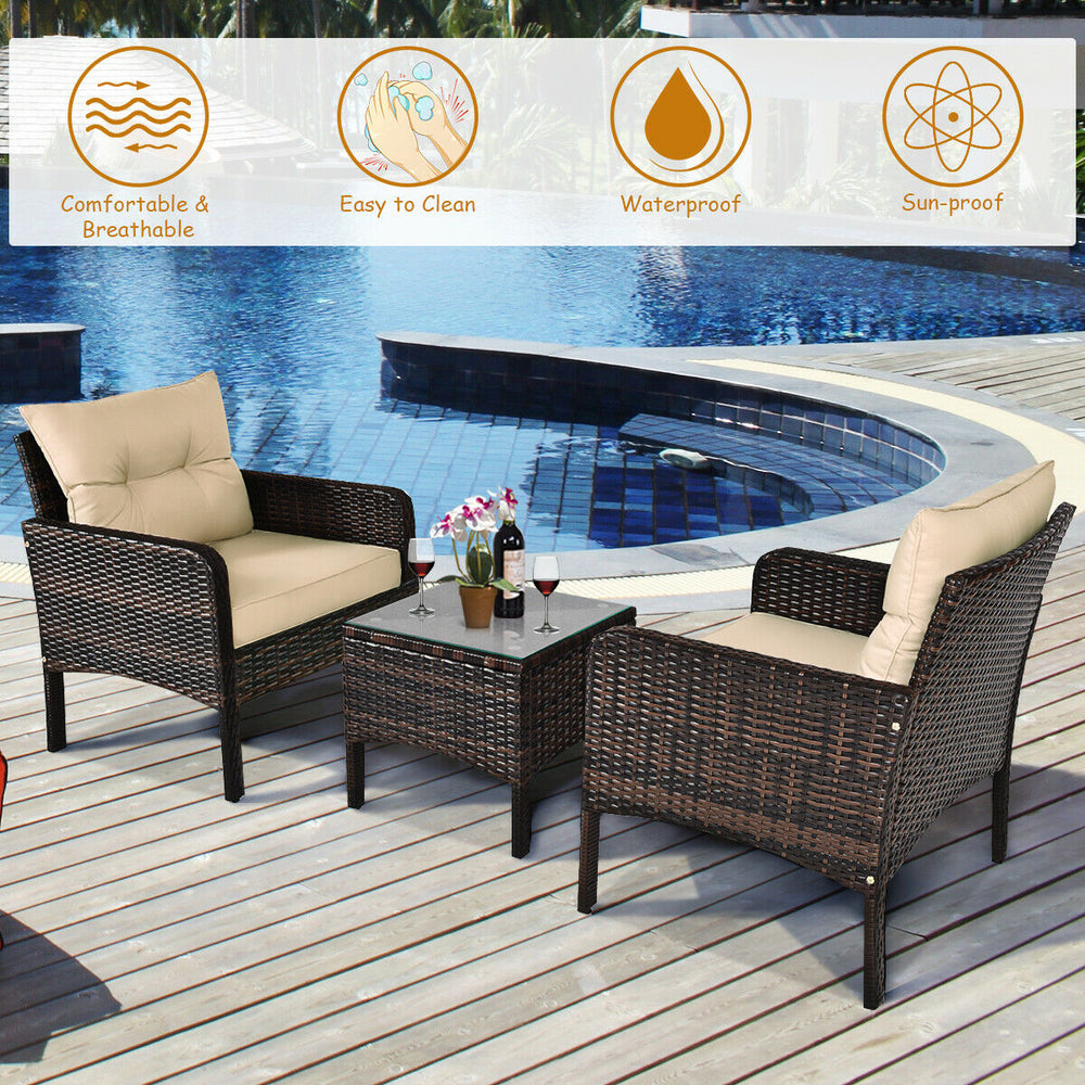 Outdoor patio rattan conversation set with beige cushions, featuring a tempered glass table, perfect for backyard.
