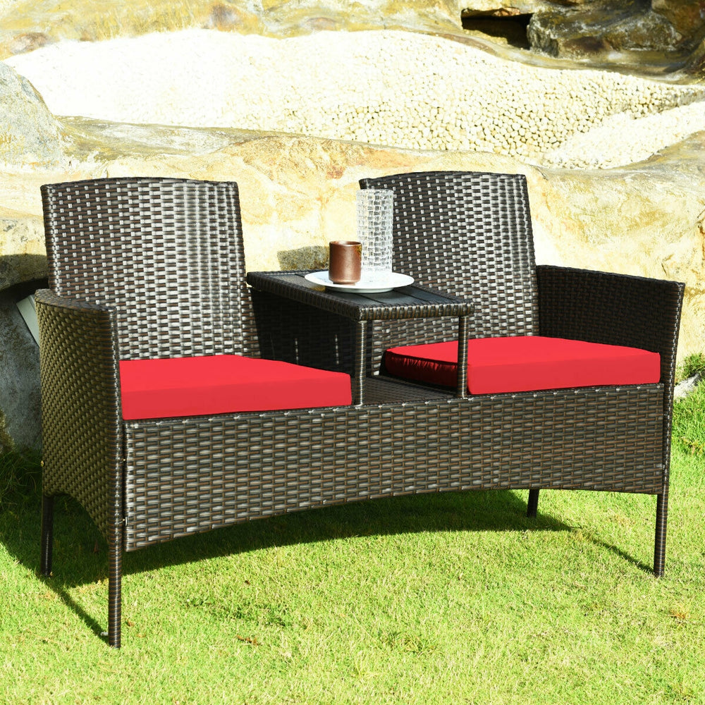 Modern patio conversation set featuring a trapezoid coffee table, red cushions, and durable rattan for outdoor.
