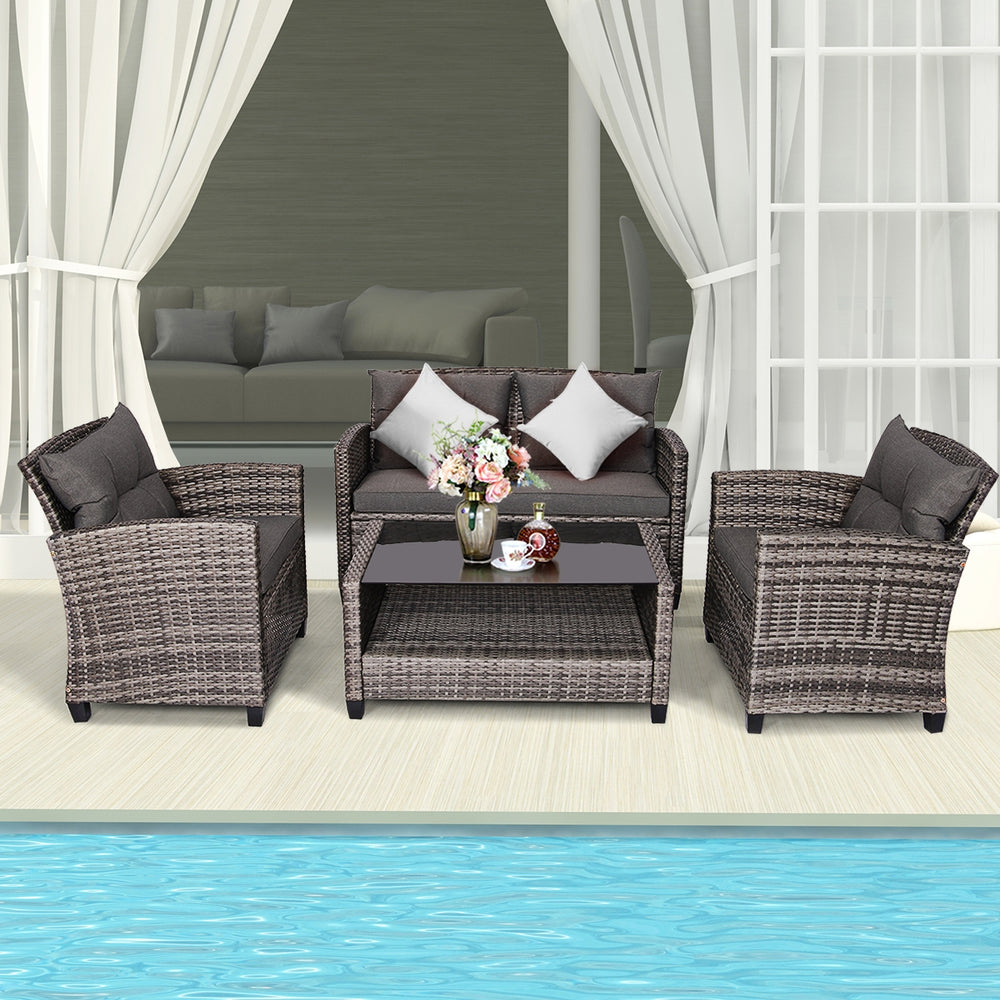 Modern 4-piece patio rattan furniture set with gray cushions, including a coffee table, loveseat, and two single sofas.