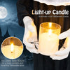 Life-size animated nun decoration holding a flickering light-up candle for a haunting Halloween atmosphere.