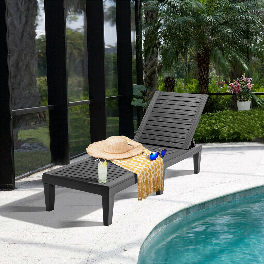 Black outdoor recliner chair with a 5-position adjustable backrest, perfect for poolside relaxation and easy transport.