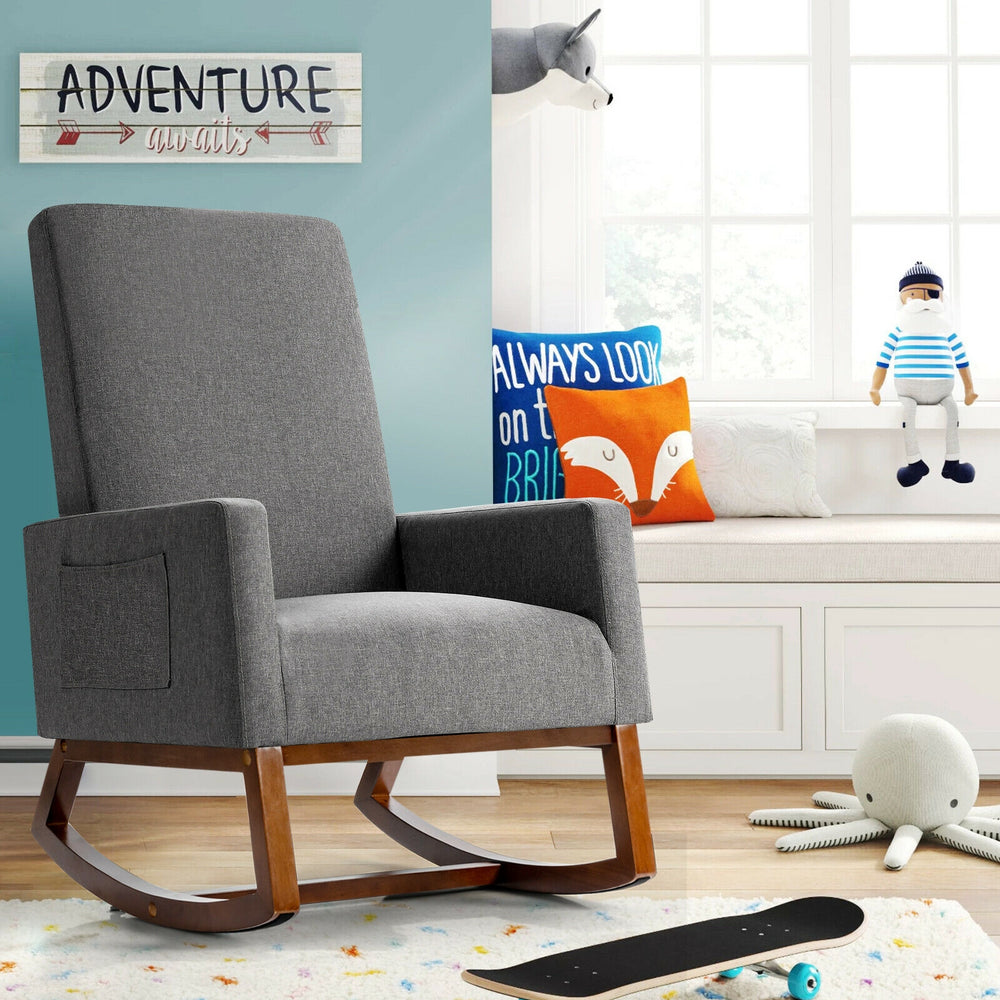 Gray rocking high back upholstered lounge armchair showcasing thickly padded seat and wide armrests for maximum comfort.