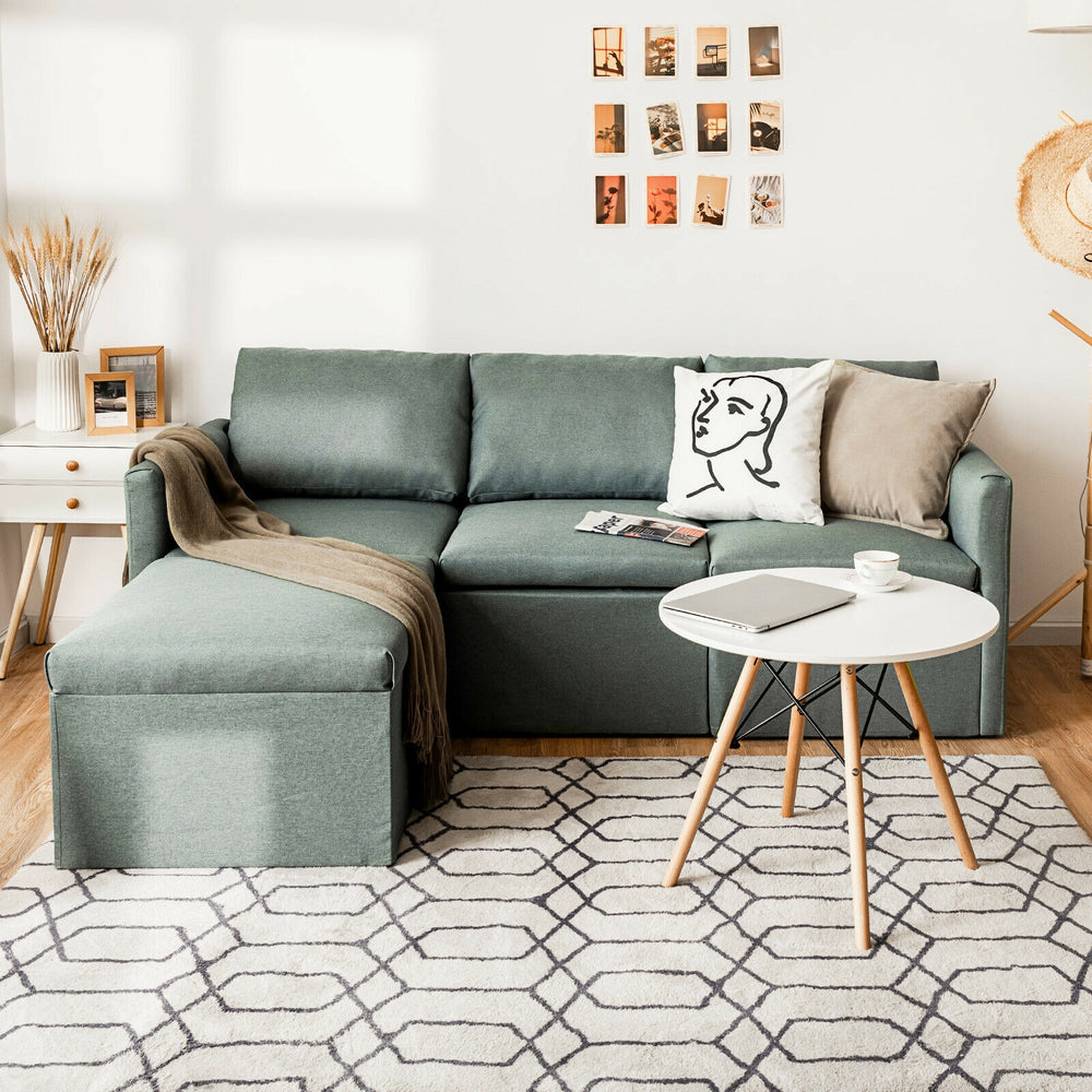 Convertible L-shaped sectional sofa in green with reversible chaise, featuring soft linen fabric and slanted backrest.