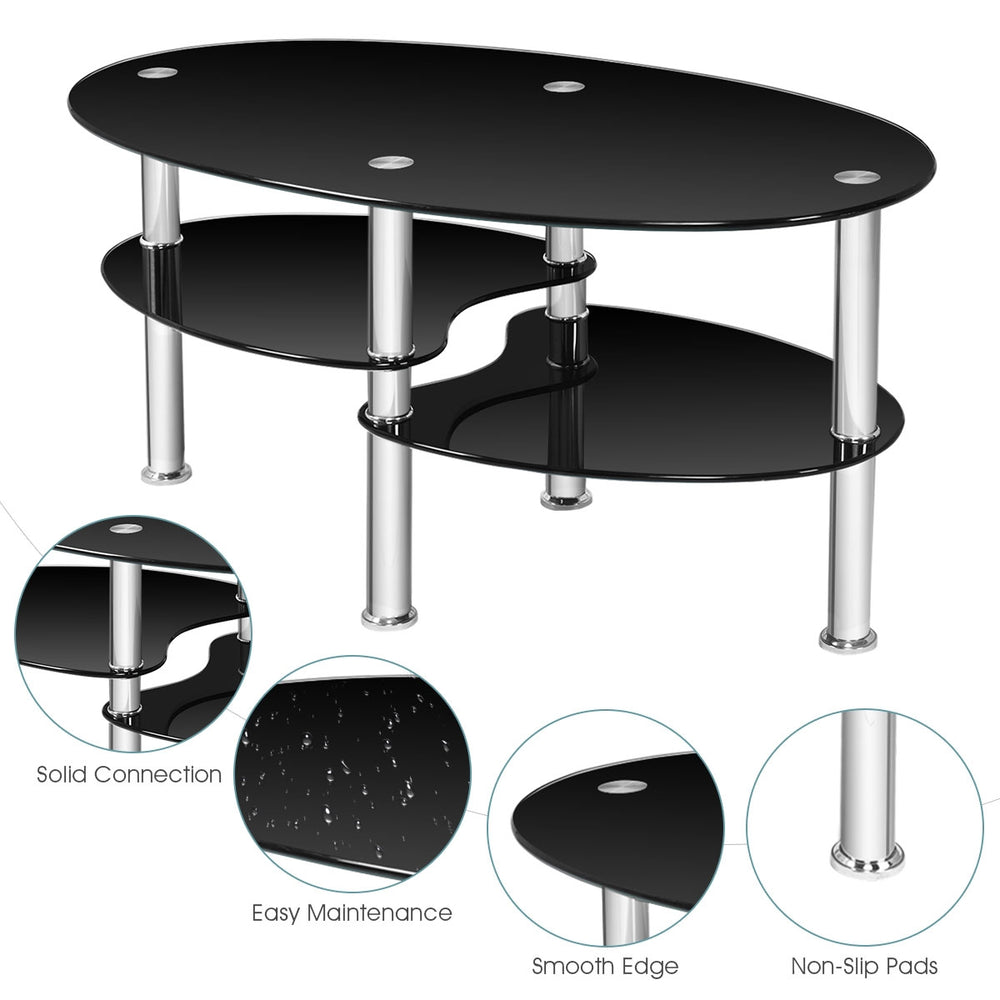 Tempered glass oval coffee table in black with two bottom shelves for storage, ideal for living room use.