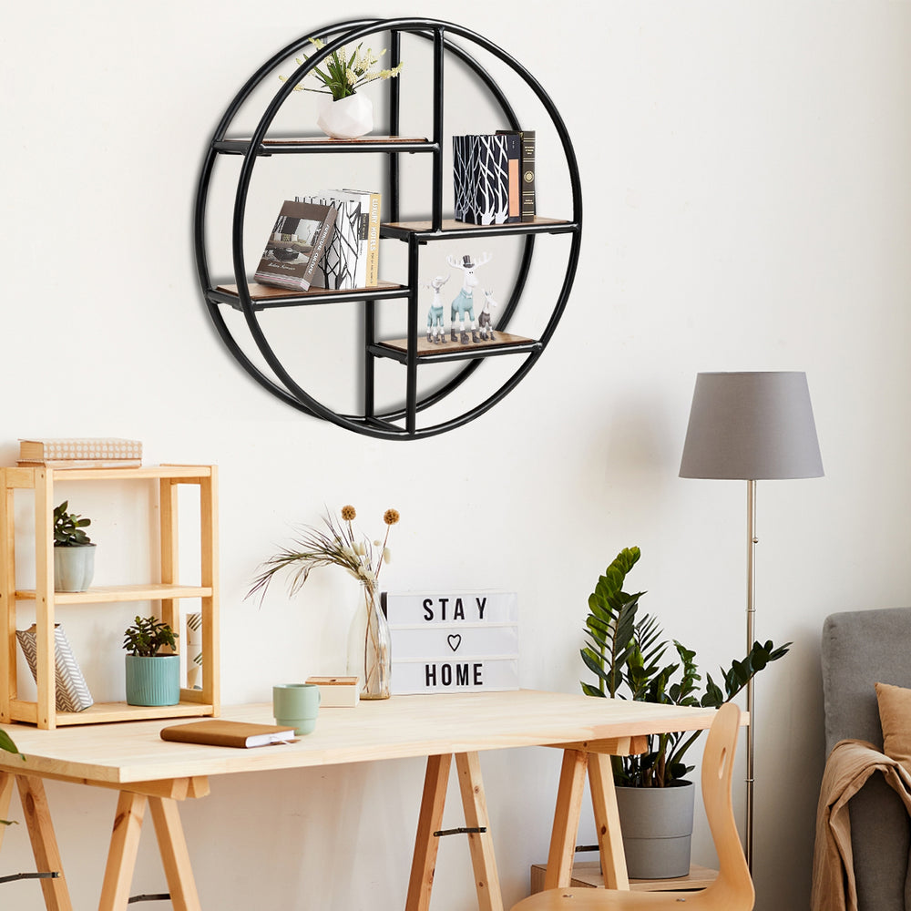 Circular wall-mounted 4-tier rack in black metal, ideal for displaying plants and decor in modern minimalist spaces.