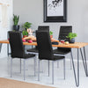Black PVC leather dining side chairs with painted steel legs, elegantly arranged around a wooden table in a modern.
