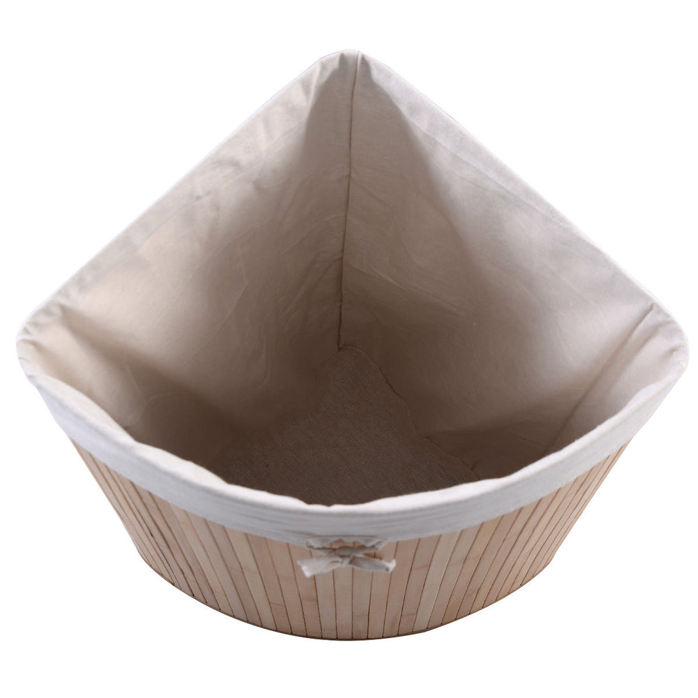 Corner bamboo laundry basket with a natural finish, featuring a removable liner and convenient PU leather handles.