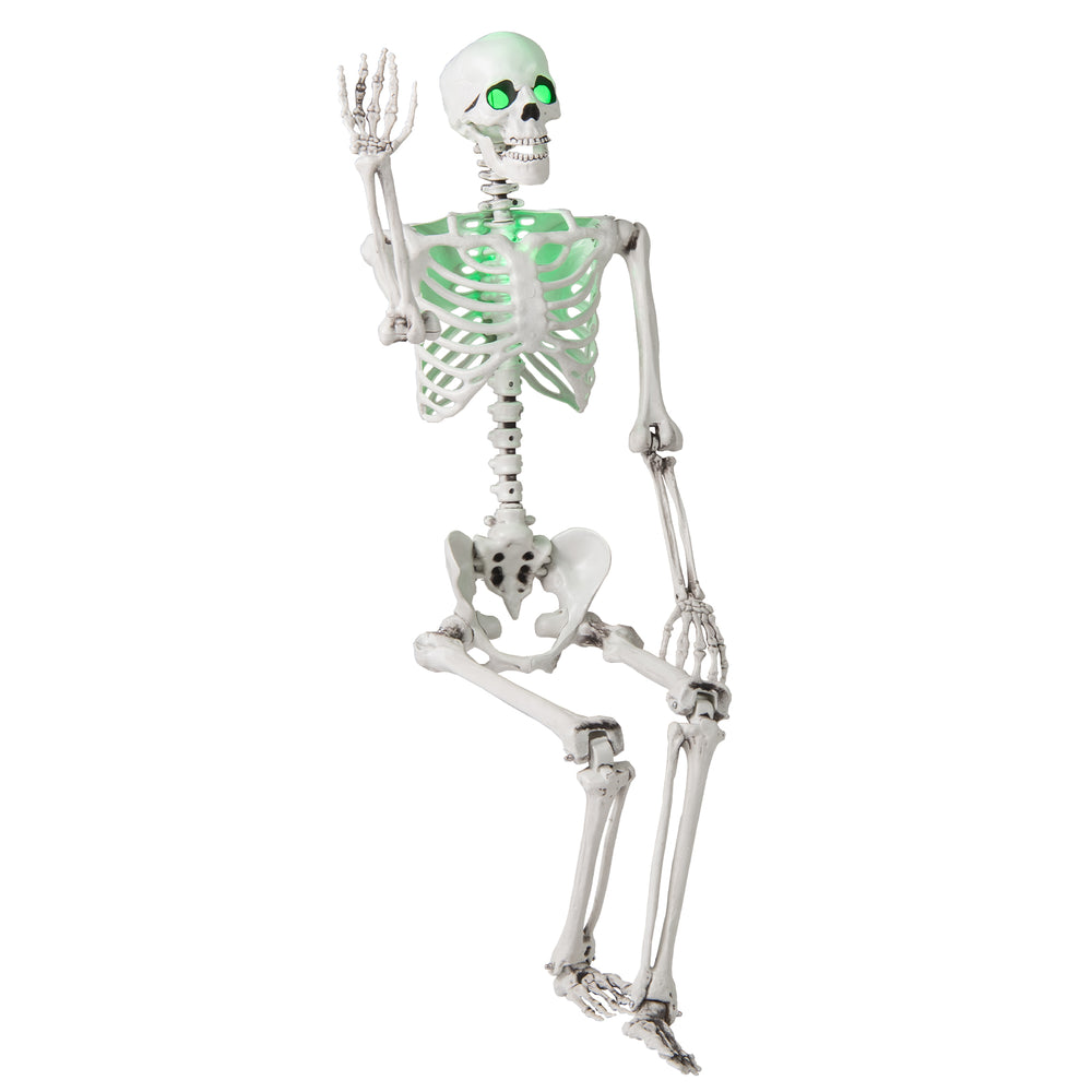 Life-size 5.5 FT Halloween skeleton, posable with glowing green eyes, ideal for indoor or outdoor decoration.