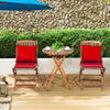 Folding bistro set featuring two red cushioned chairs and a round acacia wood coffee table for outdoor relaxation.