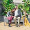 Gray HDPE patio Adirondack chair with two people seated, ideal for outdoor relaxation on the porch or backyard.