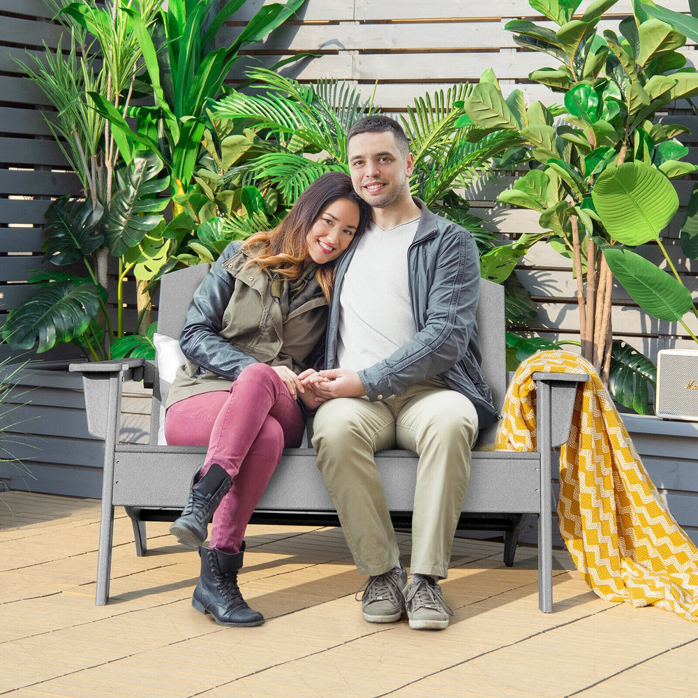 Gray HDPE patio Adirondack chair with two people seated, ideal for outdoor relaxation on the porch or backyard.