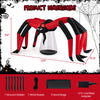 Halloween inflatable spider with red tunnel light eyes, 10-ft span, secured with sandbags and stakes for outdoor use.