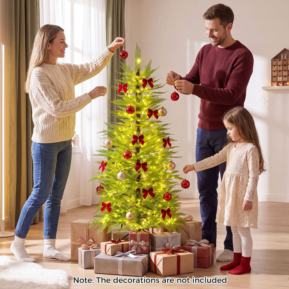 Family decorates a 5 FT pre-lit artificial Christmas tree with 670 warm white lights for festive celebrations.