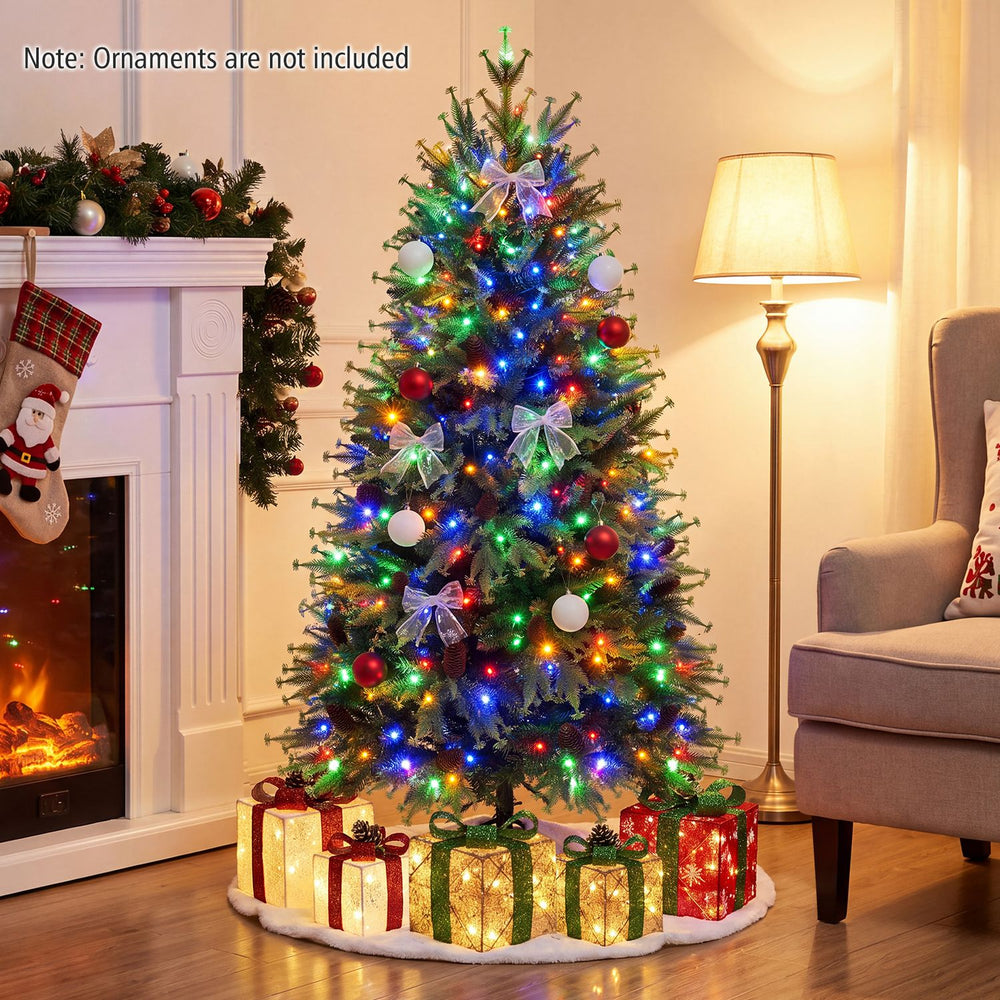5 FT pre-lit artificial Christmas tree with multicolor LED lights, pine cones, and mixed branch tips in a festive living room.