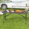 5FT folding picnic table with wood grain HDPE tabletop, set outdoors with food and drinks, ideal for gatherings.