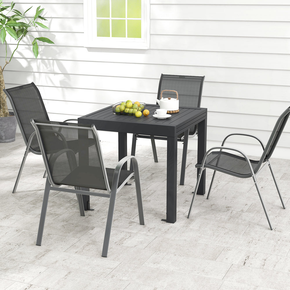 Outdoor dining table set featuring an extendable aluminum table and 4 stackable chairs, perfect for patios and.