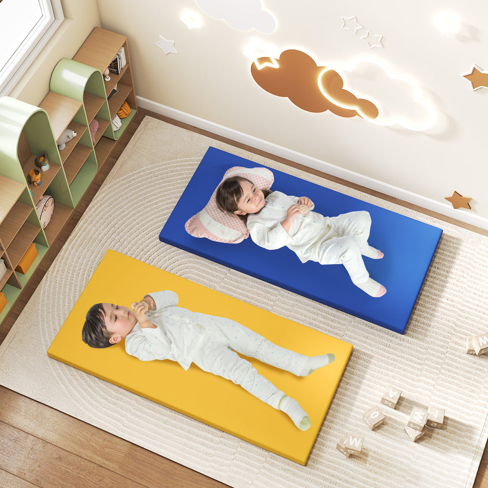 Two toddlers resting on colorful nap mats in a playroom, featuring blue and yellow PU leather for easy cleaning.