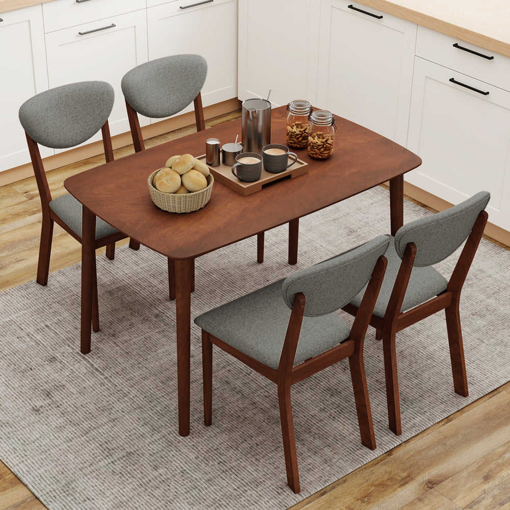 Rectangular dining table with four ergonomic fabric chairs in gray, perfect for kitchens or breakfast nooks.