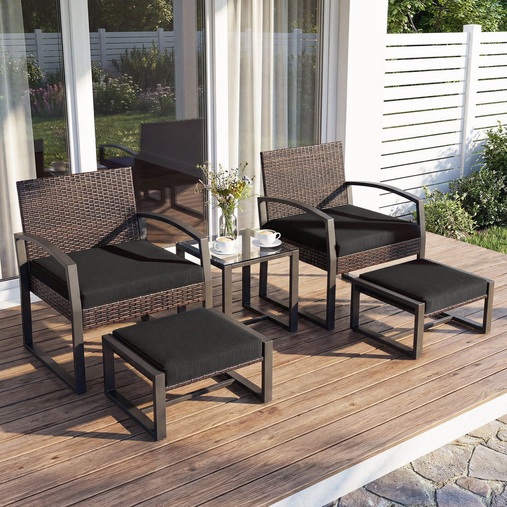 5-piece patio conversation set featuring two black cushioned chairs, two ottomans, and a tempered glass side table.