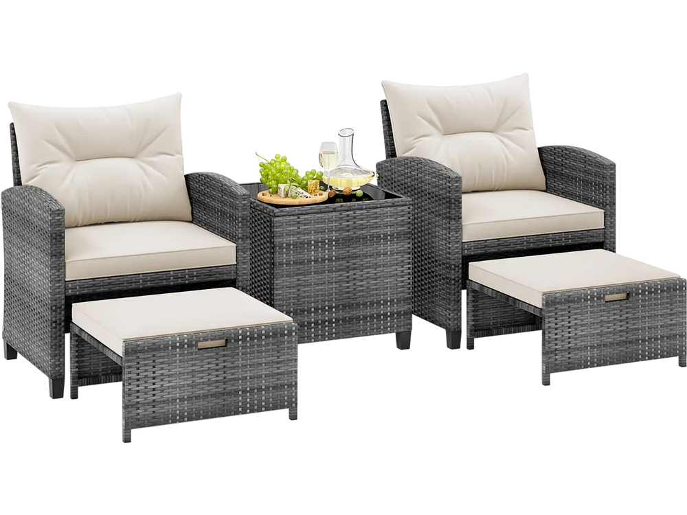 Two gray rattan chairs with cream cushions, two ottomans, and a tempered glass coffee table for outdoor relaxation.