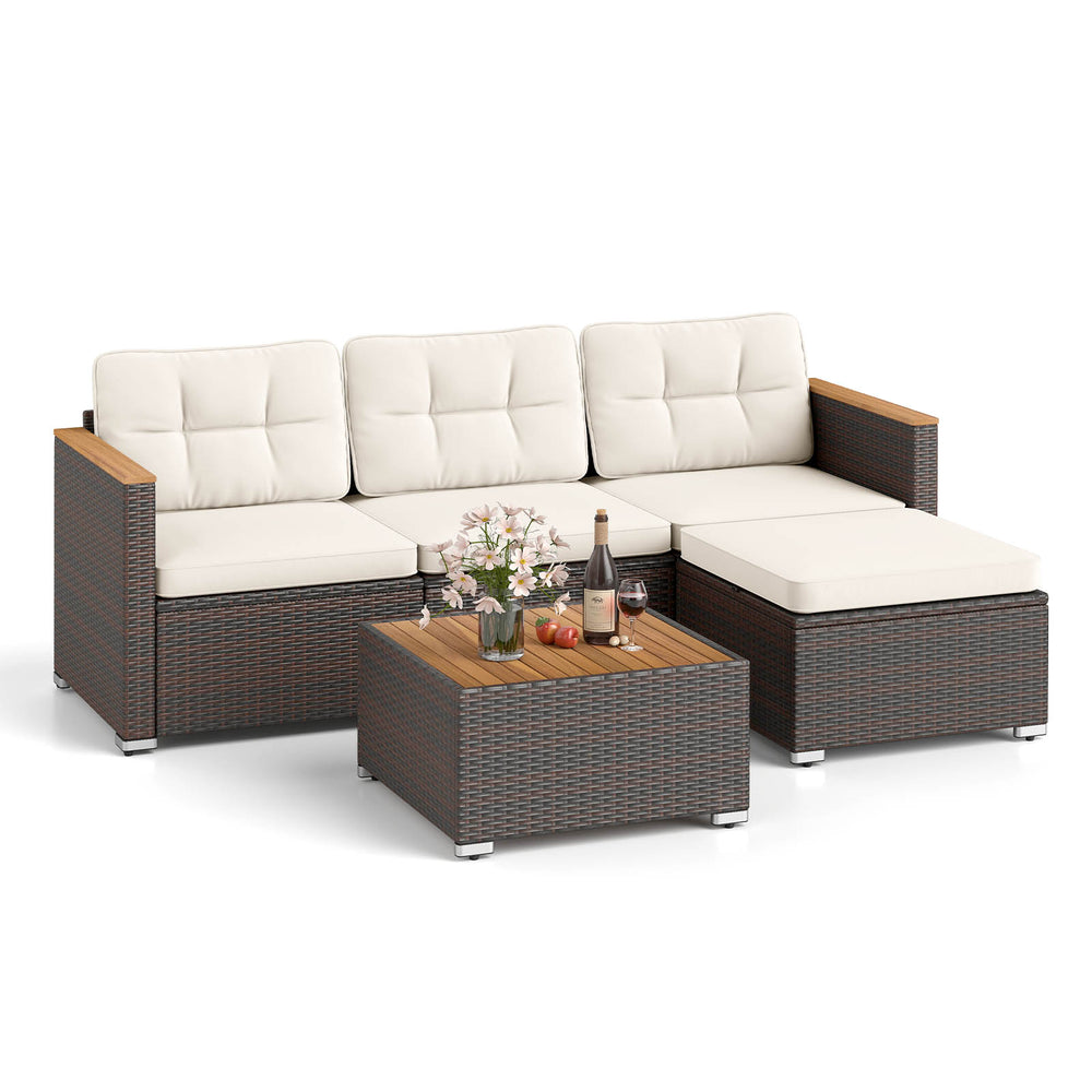 5-piece wicker conversation set with white cushions, acacia wood accents, and coffee table for stylish outdoor seating.