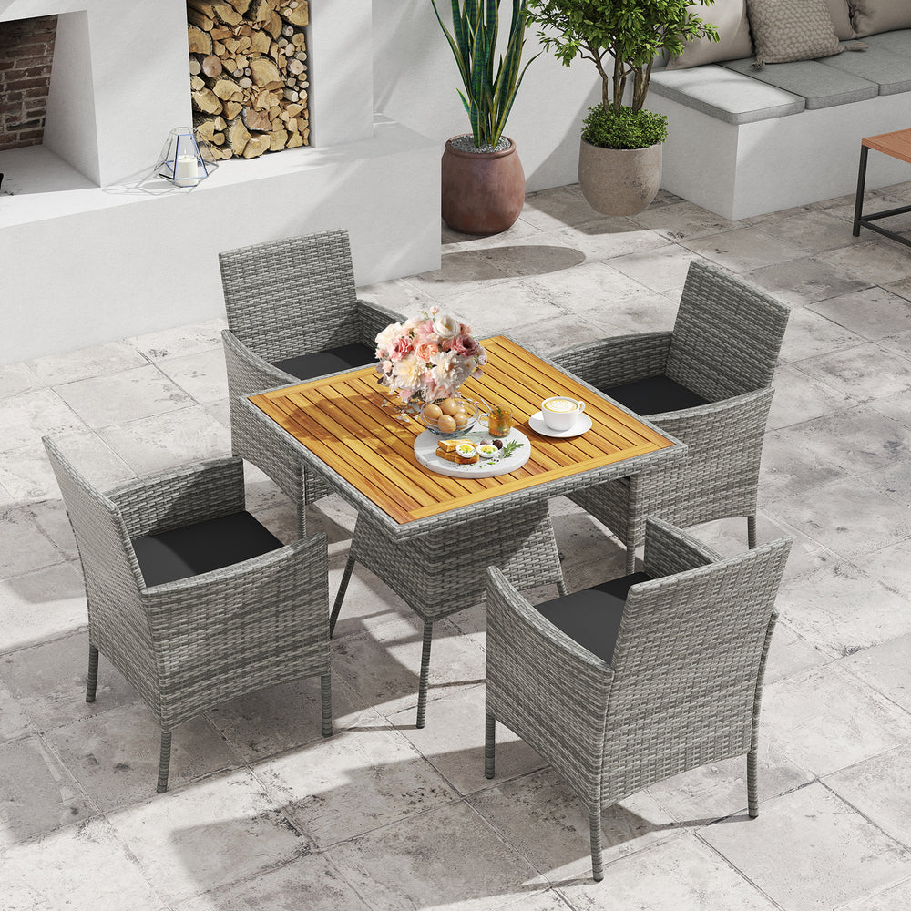 5-piece PE wicker patio dining set with acacia wood table and chairs, featuring soft cushions for outdoor comfort.
