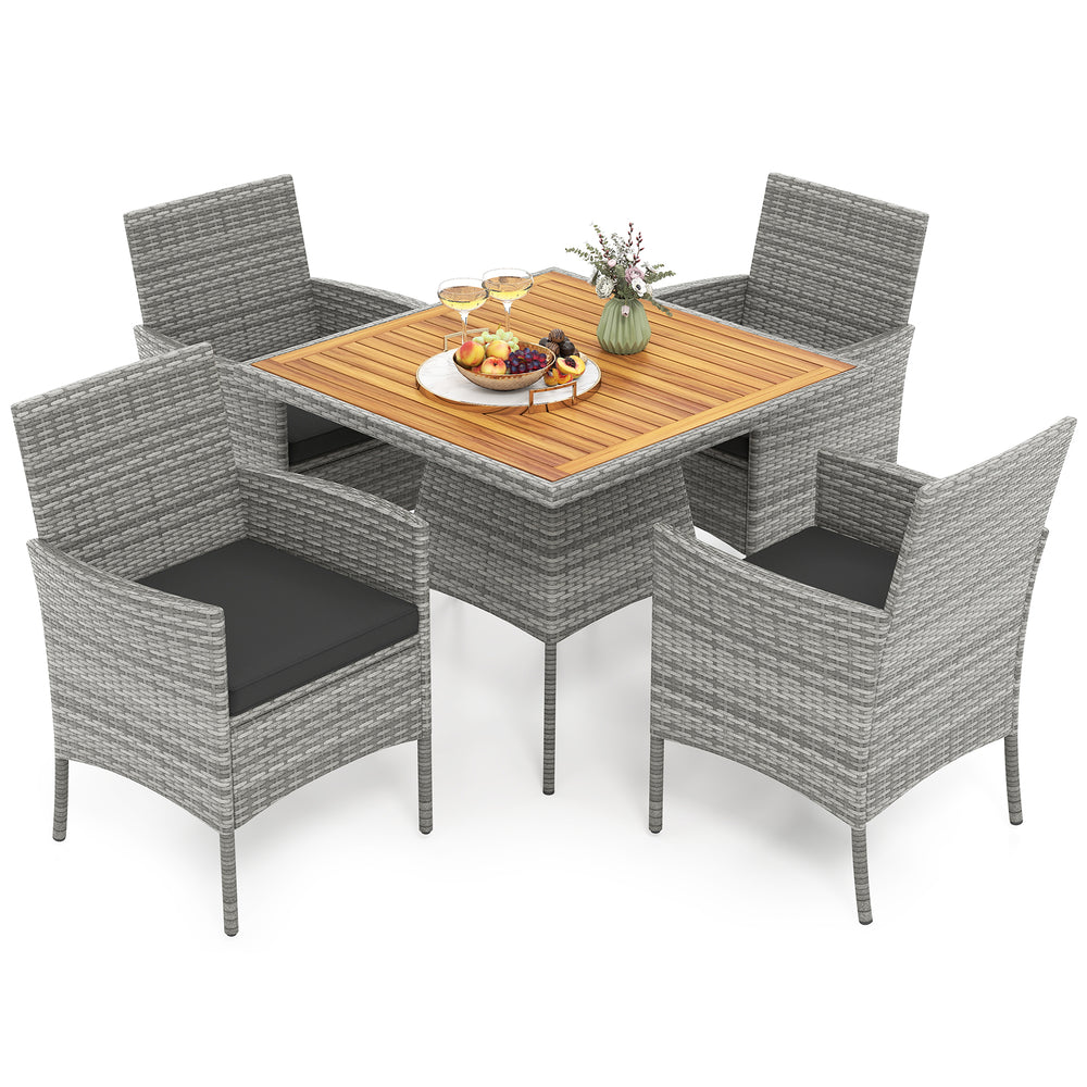 5-piece PE wicker patio dining set with acacia wood table and black cushions, ideal for outdoor dining and relaxation.