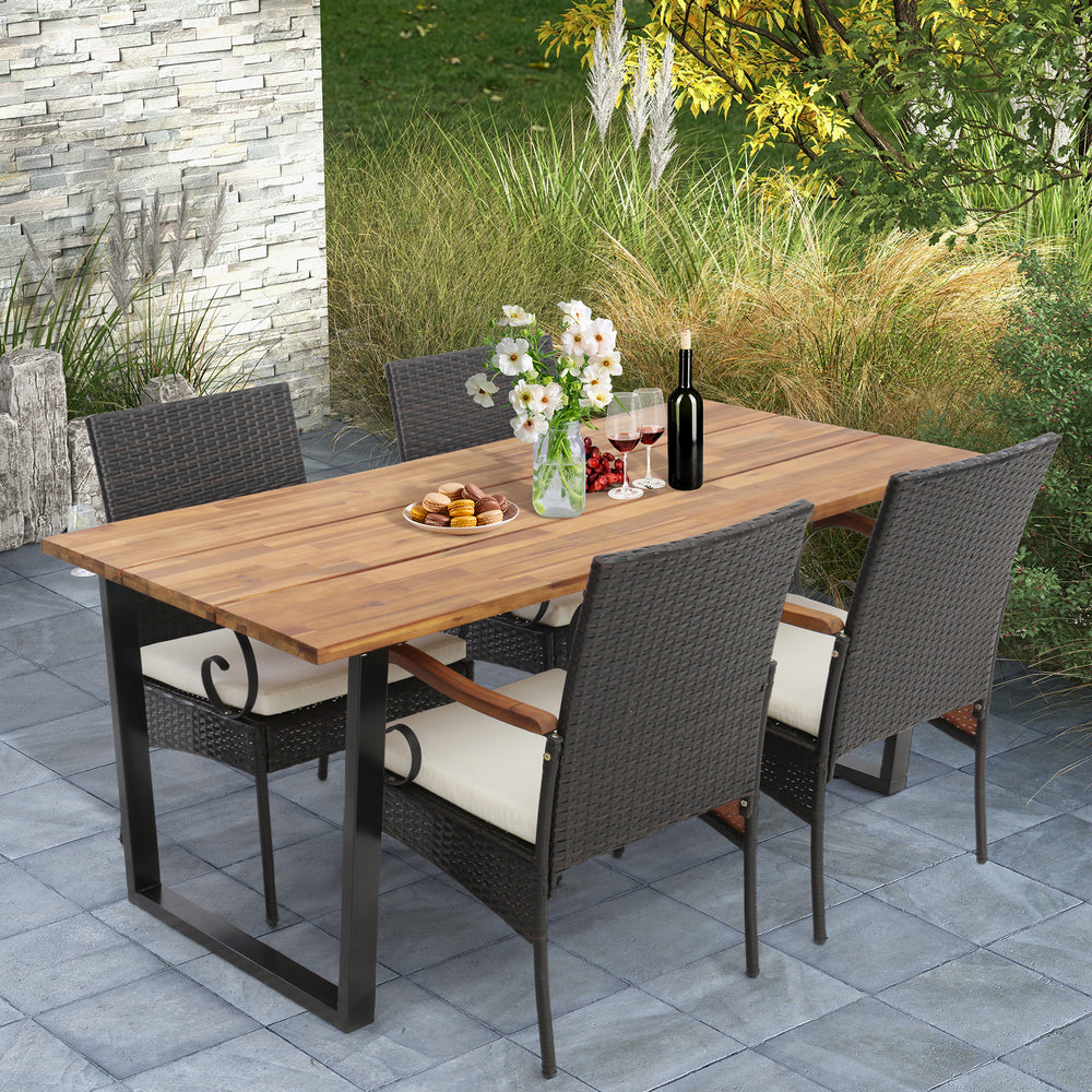 5-piece patio rattan dining set with acacia wood tabletop and cushions, perfect for poolside or backyard dining.