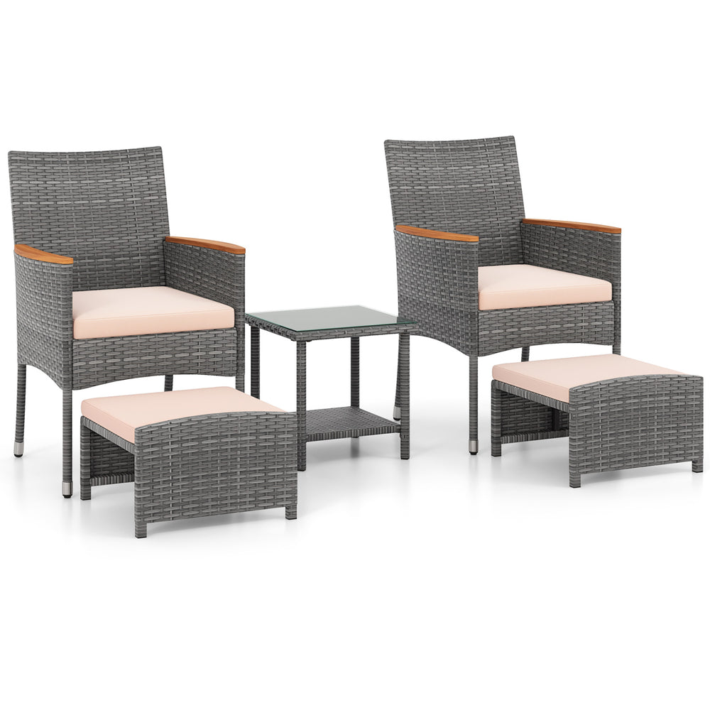 Patio conversation set featuring two armchairs, ottomans, and a side table with grey PE rattan and soft beige cushions.