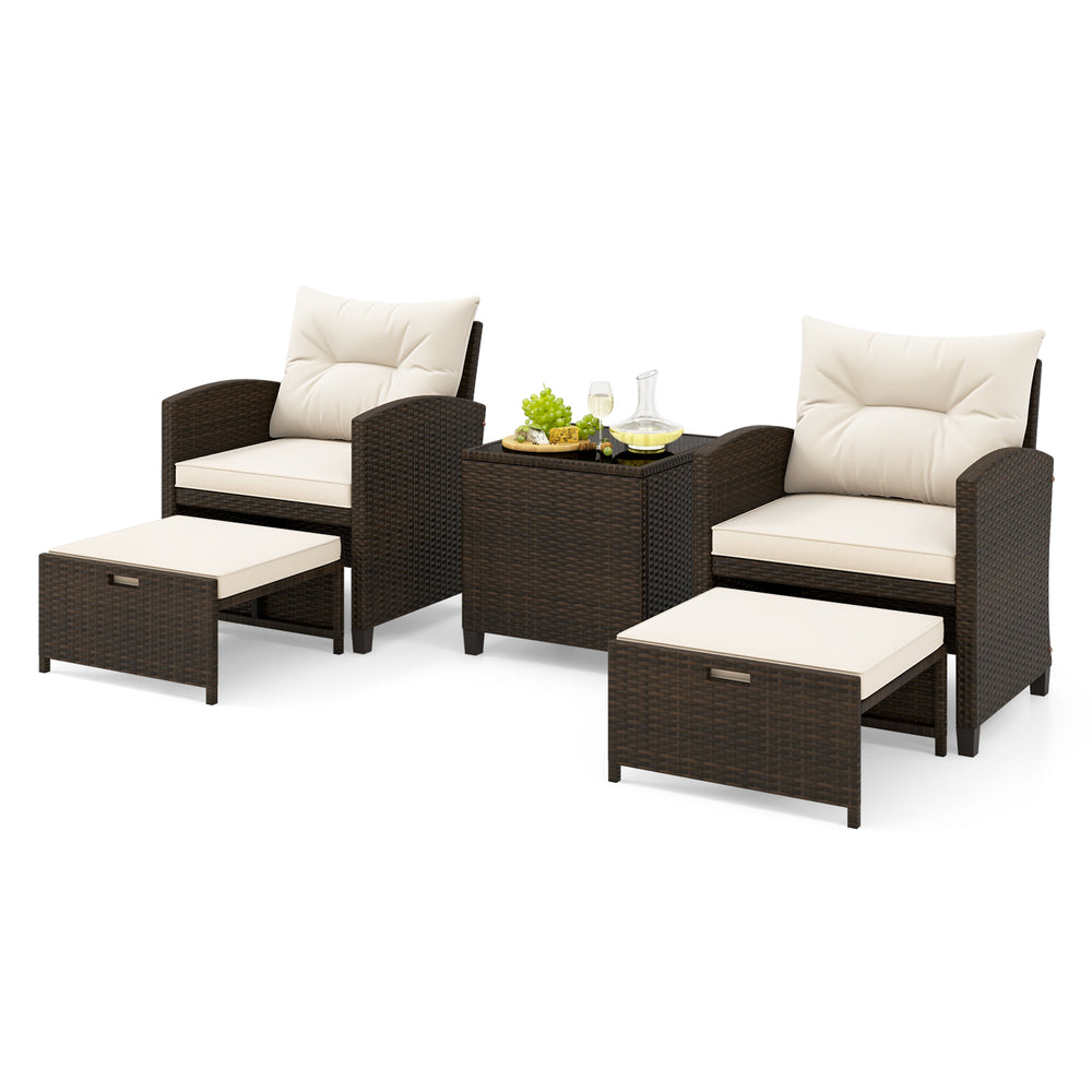 5-piece patio rattan furniture set with off-white cushions, including 2 ottomans and a tempered glass coffee table.