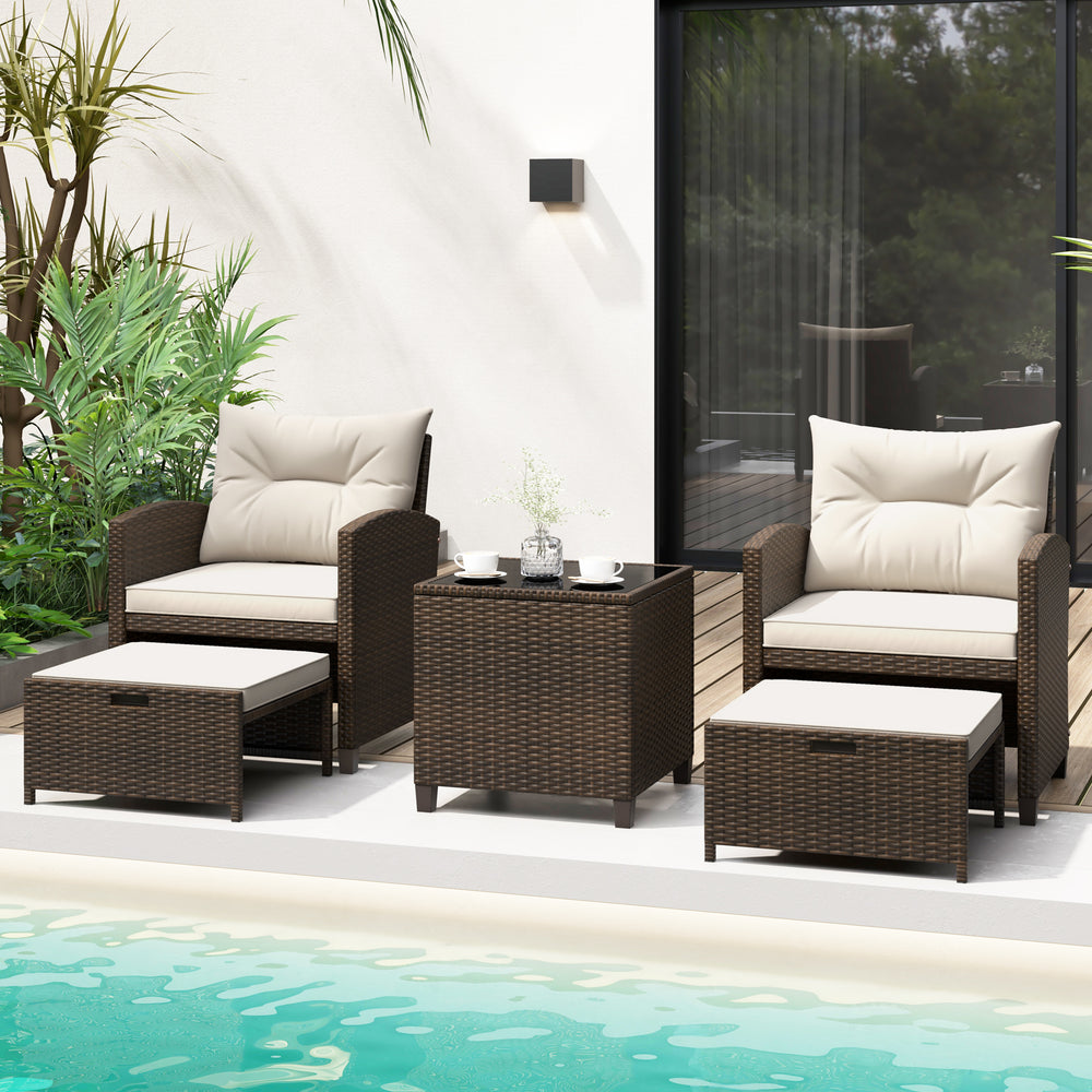 Patio rattan furniture set featuring two ottomans and a tempered glass coffee table, ideal for outdoor relaxation.