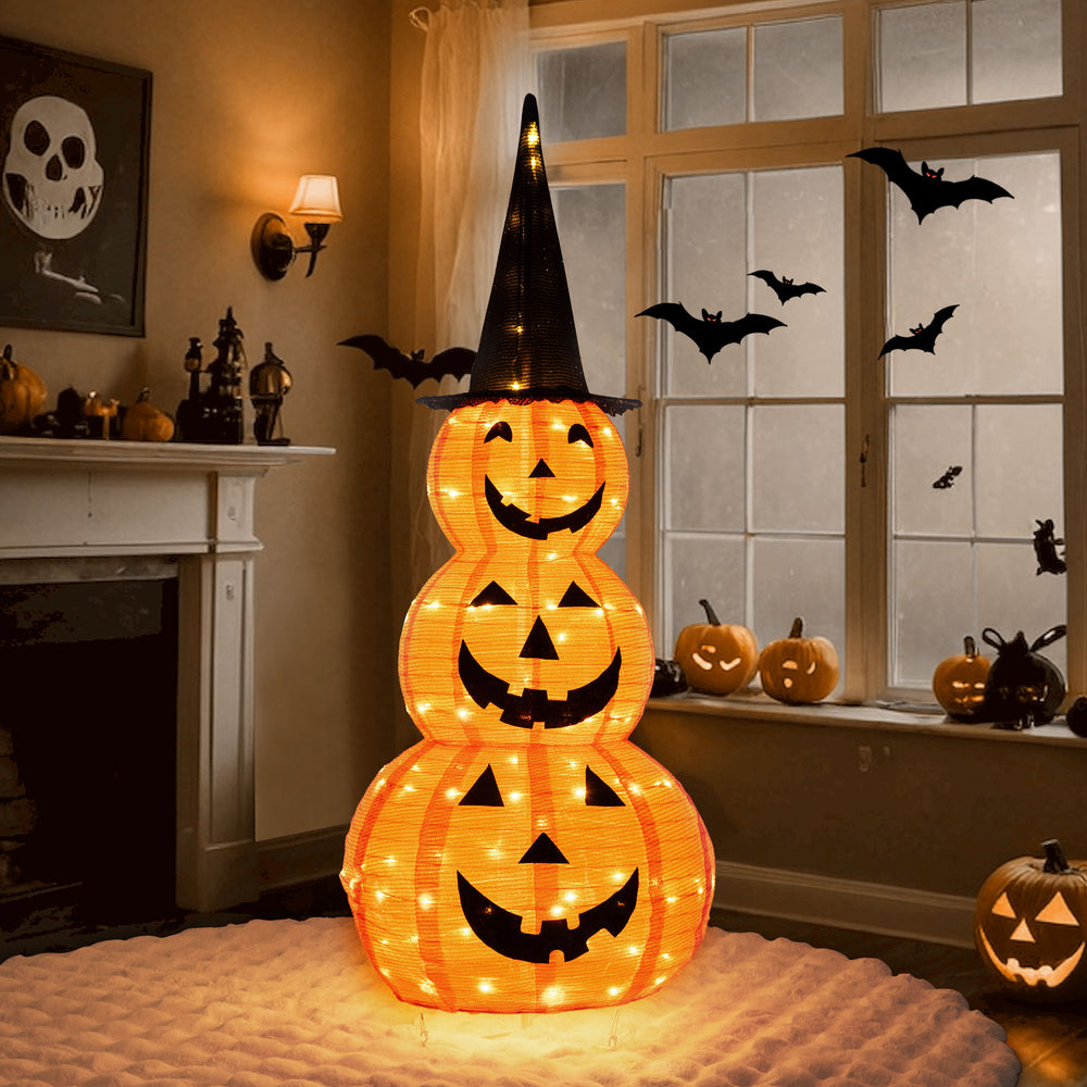 Lighted stacked pumpkin decoration with witch hat, featuring 100 LED lights, ideal for Halloween yard decor.