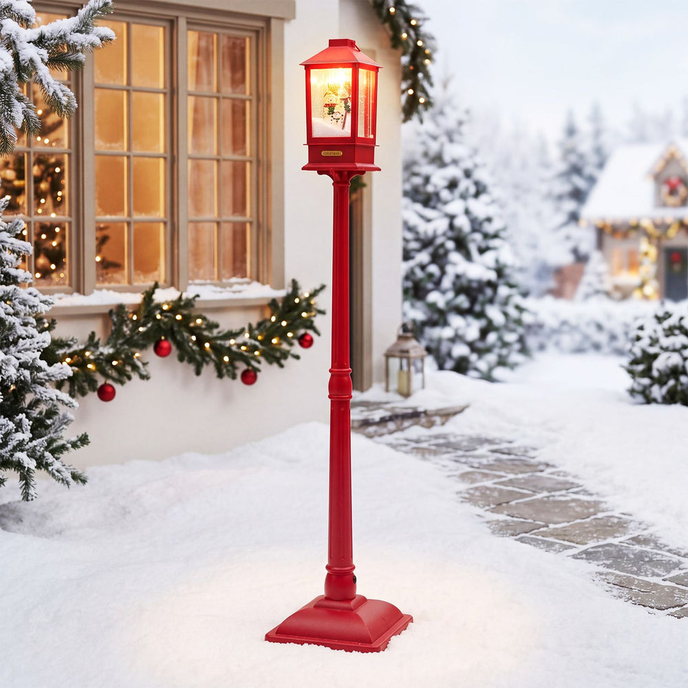 Red 5 ft Musical Christmas streetlight features LED lights and a whimsical snowman family for festive outdoor decor.