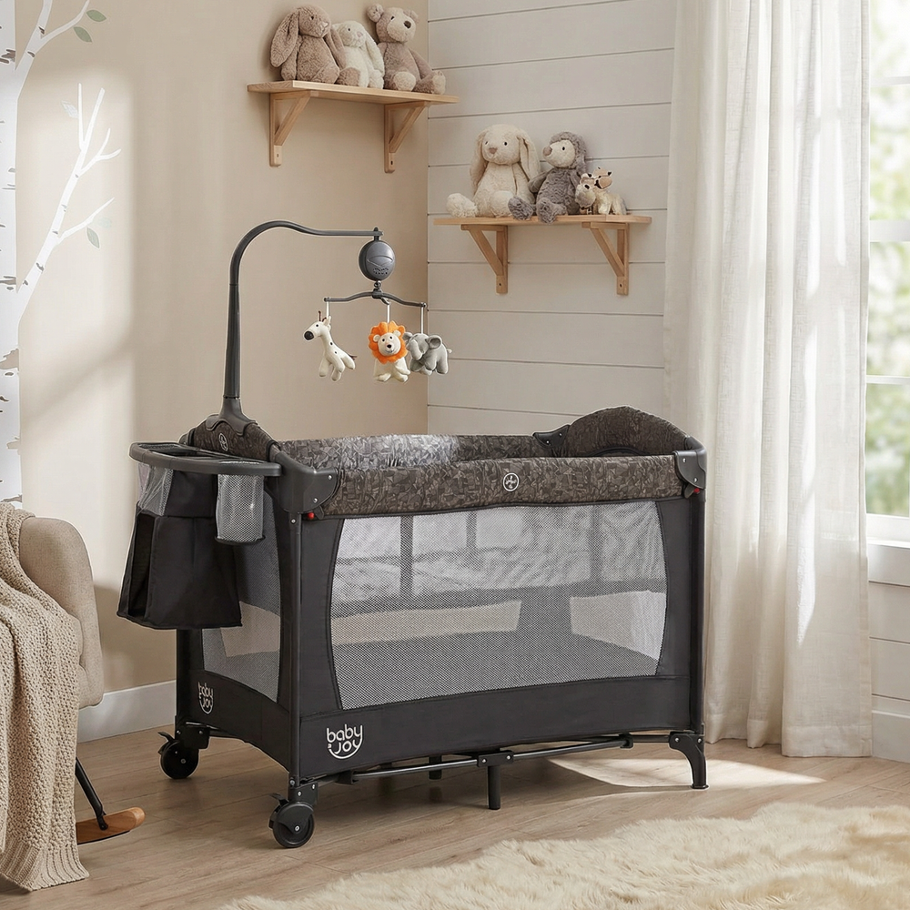 5-in-1 bedside bassinet in gray with detachable changing table, mesh panels, and plush toys for safe co-sleeping.
