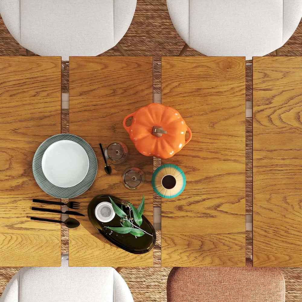 Extendable dining table with bamboo sideboard, plates, and decor, showcasing modern farmhouse style for versatile.