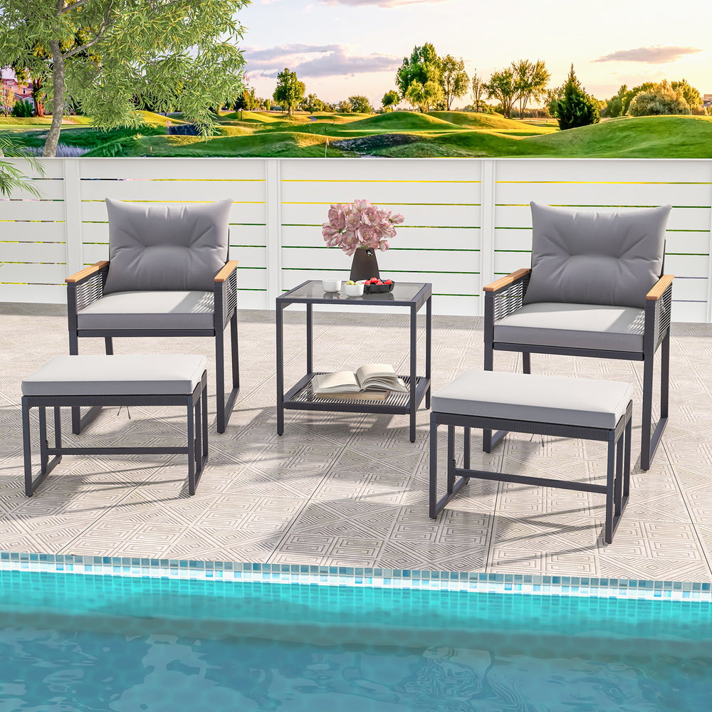 5-piece outdoor rattan conversation set with gray cushions, 2-layer side table, and 2 ottomans for poolside relaxation.
