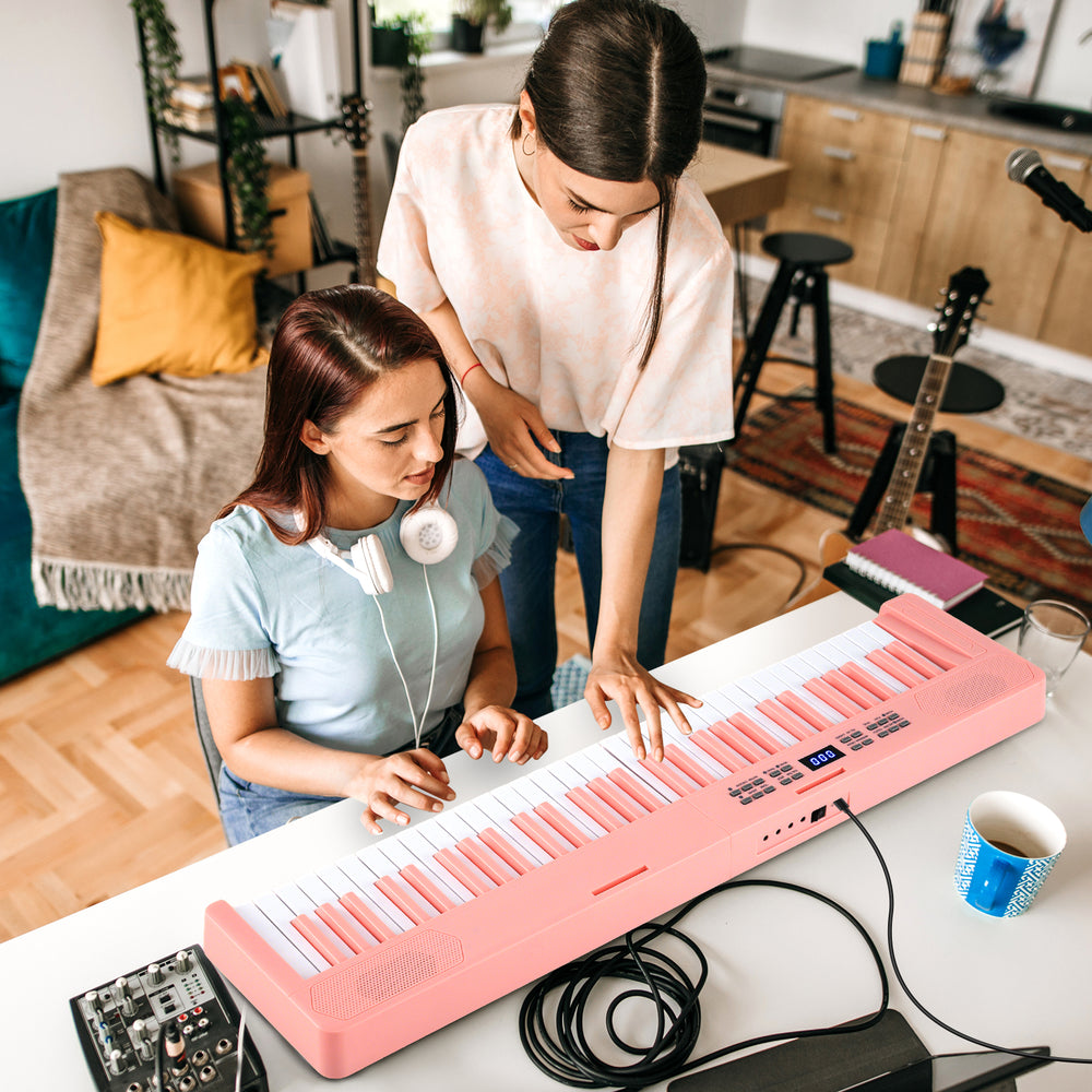 61-key foldable pink piano keyboard with MIDI function, dual keyboard, and wood grain surface for comfortable playing.