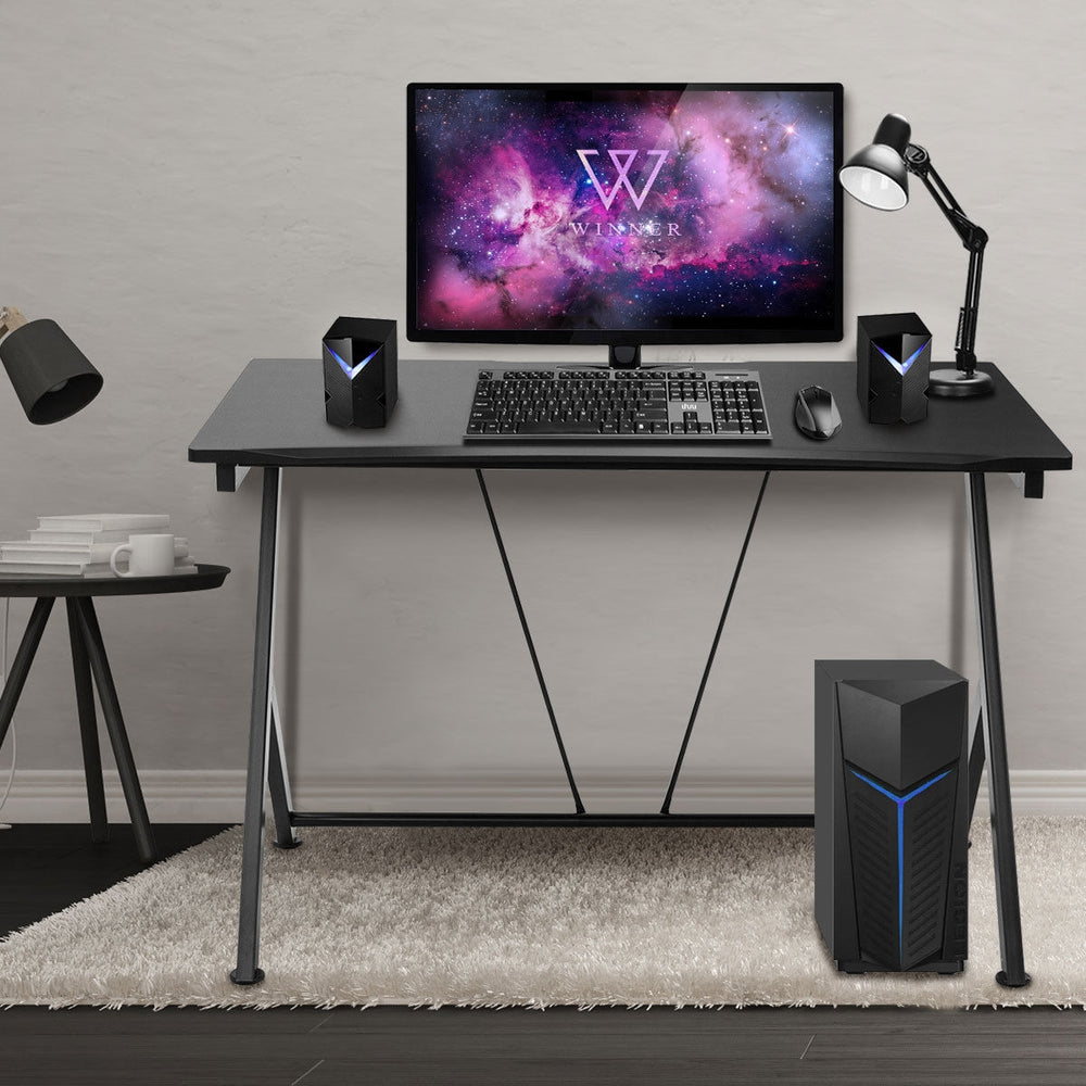 Modern ergonomic study computer desk with large MDF surface, steel legs, and ample space for monitor and keyboard.