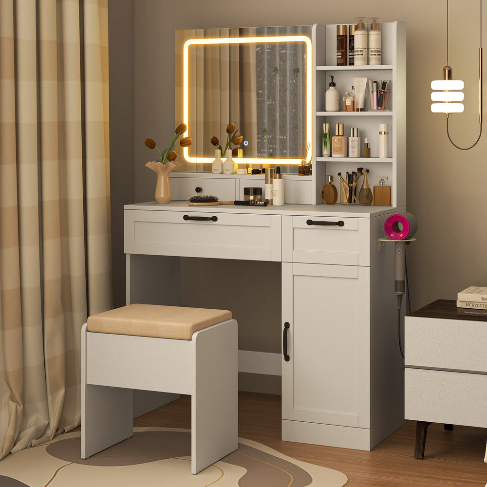 Vanity set in white featuring a mirror with adjustable lighting, storage shelves, and a comfy stool for makeup.
