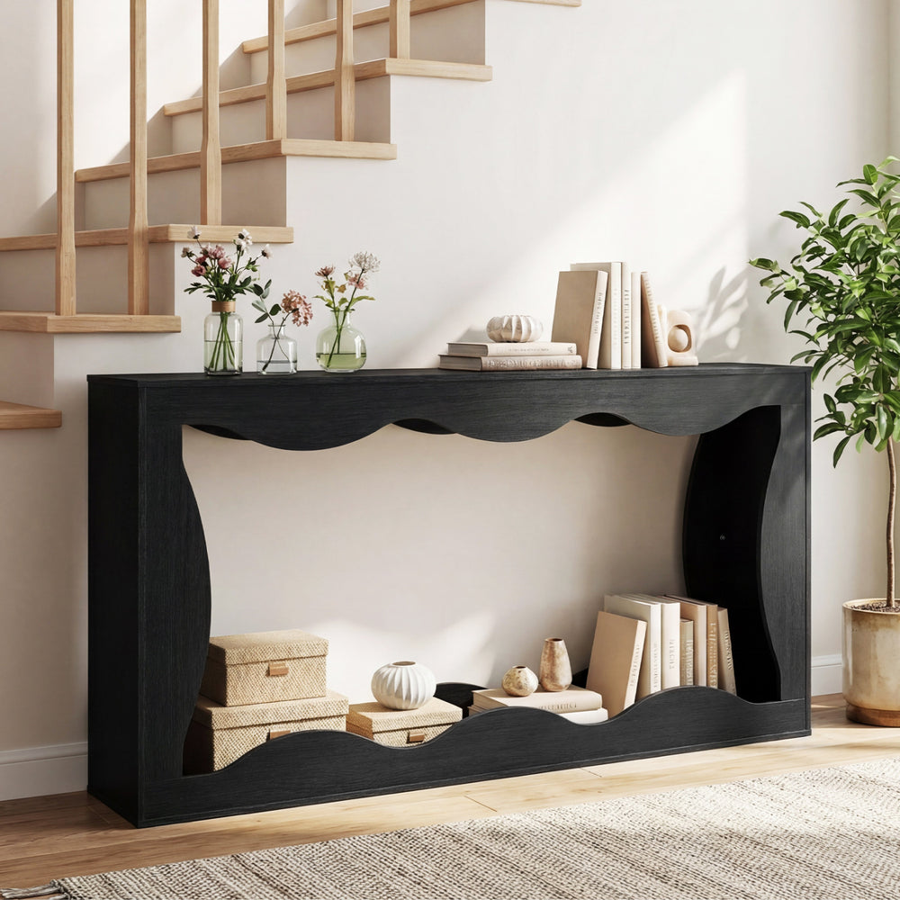 Black 63-inch console table with wavy edge design, featuring a spacious top and open bottom shelf for stylish storage.