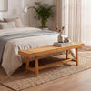 Solid wood bench in a cozy bedroom setting, featuring teak wood, 63-inch length, ideal for family gatherings.