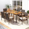 Outdoor dining table featuring a 63" acacia wood slatted top and PE rattan legs, perfect for six people on the patio.