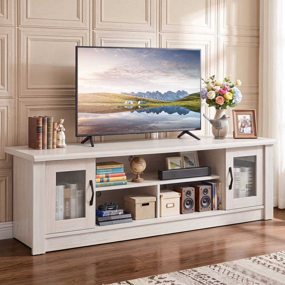 Spacious 63” wooden farmhouse TV stand in white with fluted doors and open compartments for TVs up to 70".