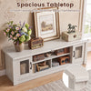 Spacious 63” wooden farmhouse TV stand in white features 2 fluted doors and 3 open compartments for ample storage.