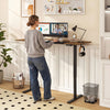 Height adjustable 63 x 24 inch computer desk in rustic brown, shown in use with dual monitors and memory presets.