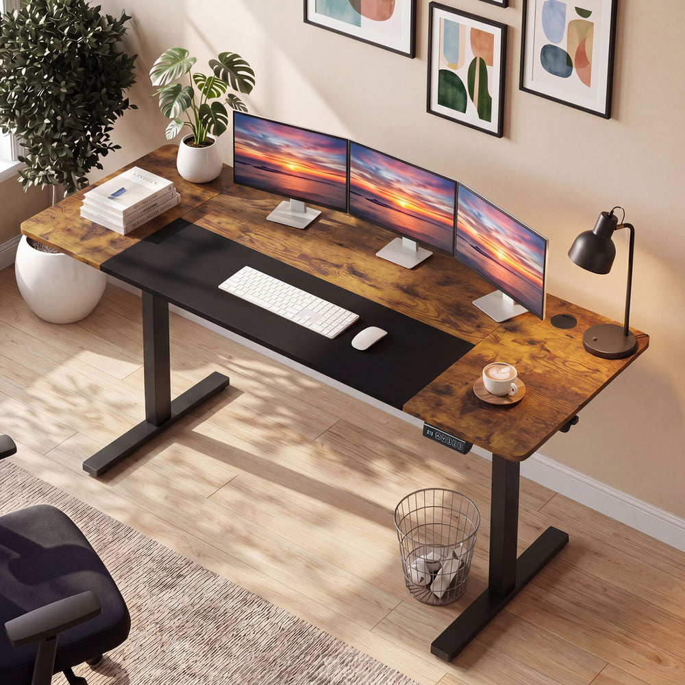 Height adjustable 63 x 24 inch computer desk in rustic brown with three monitors, featuring memory presets and cable.